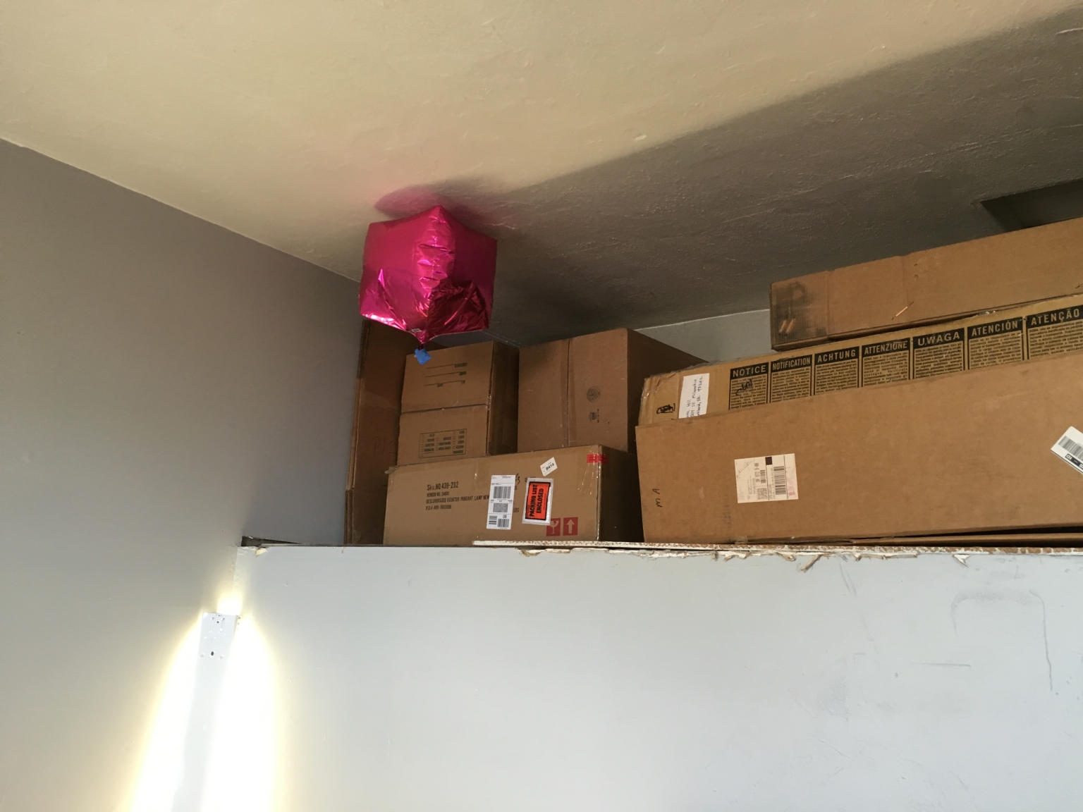 The balloon is near the ceiling